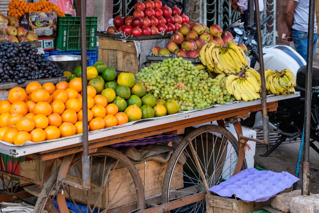 Street Vendor Selling Fruits on His Fruit Cart Photo Download free